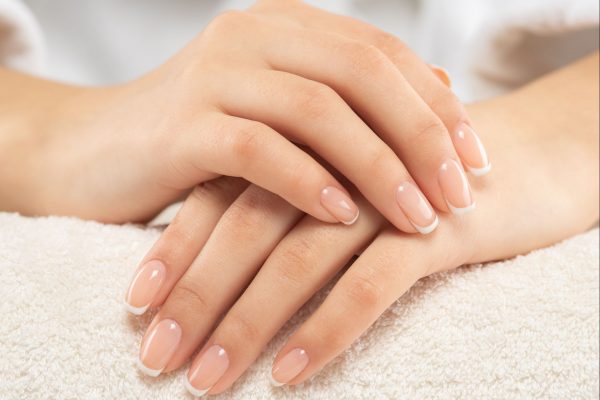 Woman gets manicure procedure in a spa salon. Beautiful female